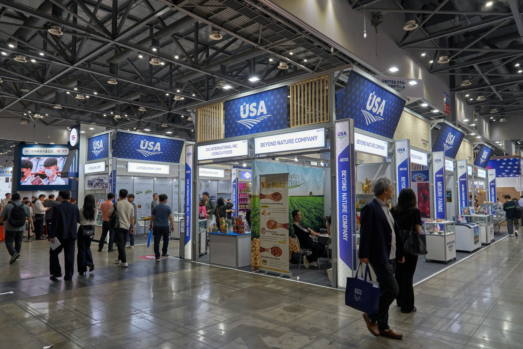 Visitors exploring product booths in a busy expo hall