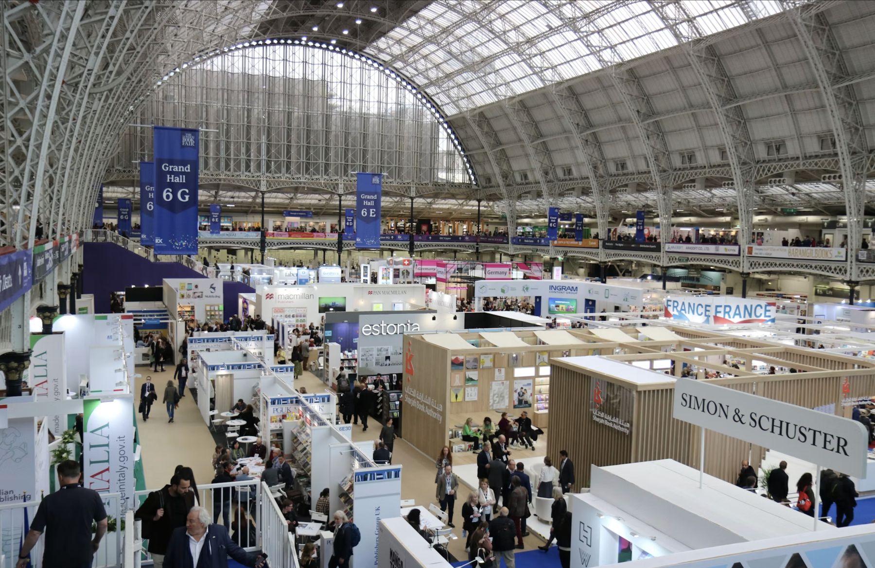Busy indoor expo hall filled with exhibition booths and visitors