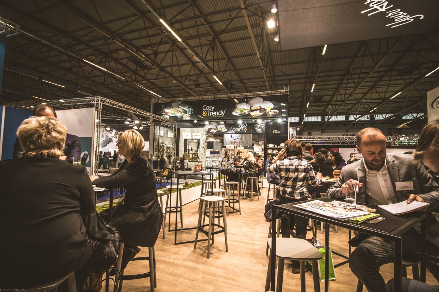 Professionals networking across a busy indoor exhibition hall