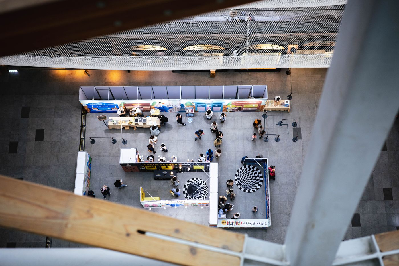 Visitors exploring branded exhibition booths from above
